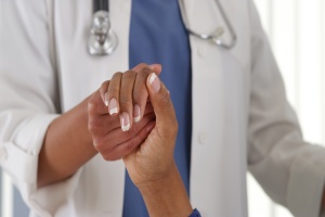 close up doctor holding hand with patient