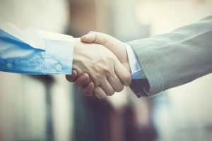 handshake between a benefits consultant and the CEO of a company
