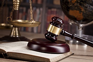 a gavel owned by an attorney who is assisting a business client with E&O insurance that has receives libel claims
