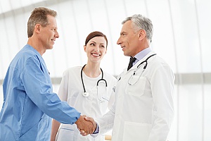 a business employee shaking hands with a doctor before a visit