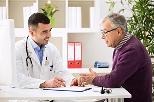 physician talking to patient that needs to cut health care costs with primary care