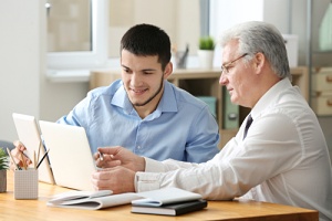 male employees doing open enrollment communication strategies