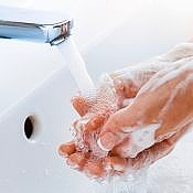 an employee being safe during a pandemic by washing their hands