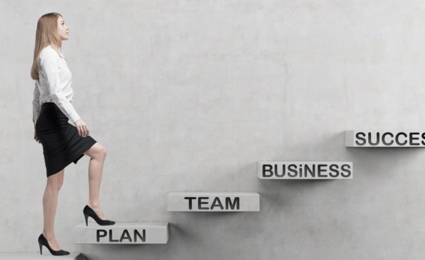 Young business woman is going up to the stairs. A concept of Disability buy-out insurance in a business succession plan