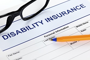 a disability insurance application with glasses and a pencil that will be filled out by a business