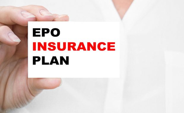 A woman holds a card that has EPO INSURANCE PLAN written on it