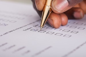 Employee filling a Survey Form. Businesses conducts survey as part of benefits renewal process