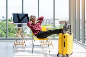 Employee Ready for Vacation with Yellow Suitcase