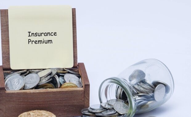What Is Insurance Premium Financing- Insurance Premium Board with Coins in Jar