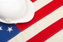 construction protective helmet laying USA flag