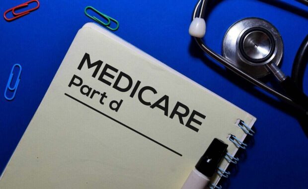 medicare part write on book isolated on wooden table