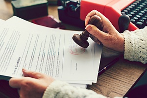 a brokers agreement on a desk getting stamped