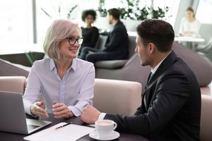 Female employee having conversation with benefit broker