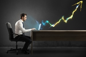 businessman working at computer with light arrow
