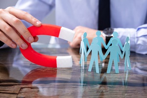 business person attracting human figures horseshoe magnet