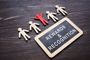 rewards and recognition words and wooden employee figures