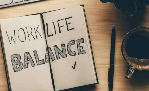 work life balance - handwrite words in open notebook