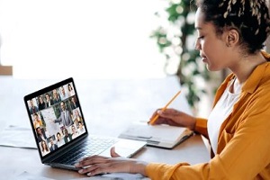 women taking notes during video call