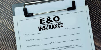 errors and omissions insurance write on document isolated on wooden table