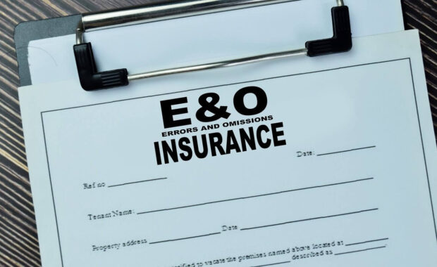 errors and omissions insurance write on document isolated on wooden table
