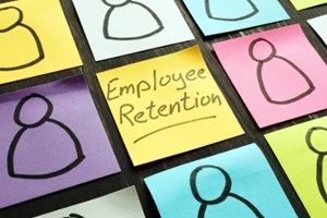 employee retention sign and figurines on the memo sticks