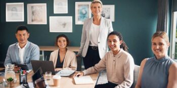 group of business people at desk with smile and confidence at meeting for employees in office